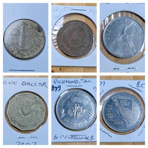 May include: Six coins in protective sleeves, showcasing diverse designs. One coin reads "2 Cents" and "British Caribbean Territory". Others feature a lighthouse, a bird, and a ship. Dates visible include 1965 and 1981. The coins are of various sizes.