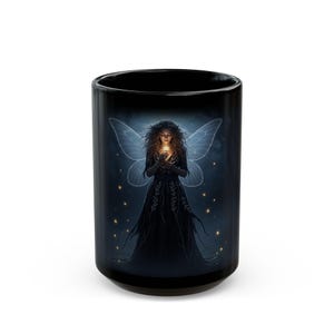 May include: Black ceramic mug with a fantasy illustration of a fairy. The fairy has glowing wings and a dark dress, holding a small, bright light. The background is dark blue with small, scattered golden lights.