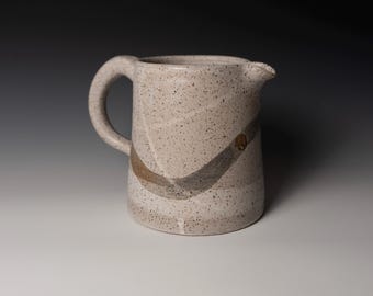 White pitcher with iron oxide decoration