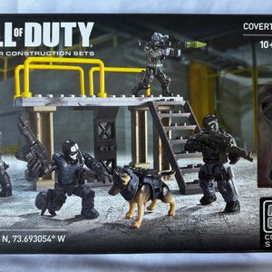 May include: A Call of Duty Collector Construction Sets box set featuring a Covert Ops Unit with 129 pieces. The set includes several action figures, a dog, and a platform with stairs. The box has the Mega Bloks Collector Series logo.