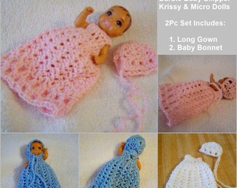 May include: A set of two crocheted doll outfits in pink, blue, and white. The outfits include a long gown and a baby bonnet. The outfits are designed for Barbie Baby Skipper Krissy & Micro Dolls. The text on the image reads "CarussDesignZ Barbie Baby Skipper Krissy & Micro Dolls 2Pc Set Includes: 1. Long Gown 2. Baby Bonnet"