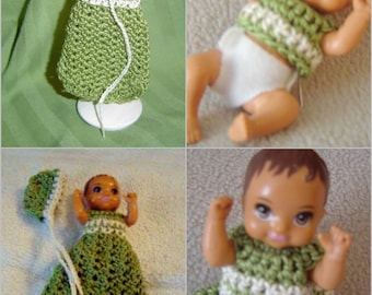 May include: A set of three crocheted outfits for baby dolls. The outfits are green and white with a crocheted hat.