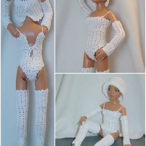 May include: A white crochet doll outfit, including a bodysuit, arm warmers, hat, and thigh-high leg warmers. The outfit is handmade with a delicate open weave pattern. The doll is wearing white boots.