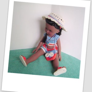 May include: A doll wearing a blue and orange crochet swimsuit, a white crochet hat, and sandals. The doll has brown skin and black hair.