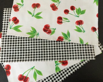 Reversible oilcloth placemats in a retro cherries on white