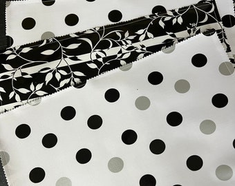 Set of four NY NY black, white and silver reversible oilcloth placemats