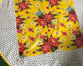 Tropical paradise . --Retro round oilcloth tablecloth with hibiscus flowers on yellow