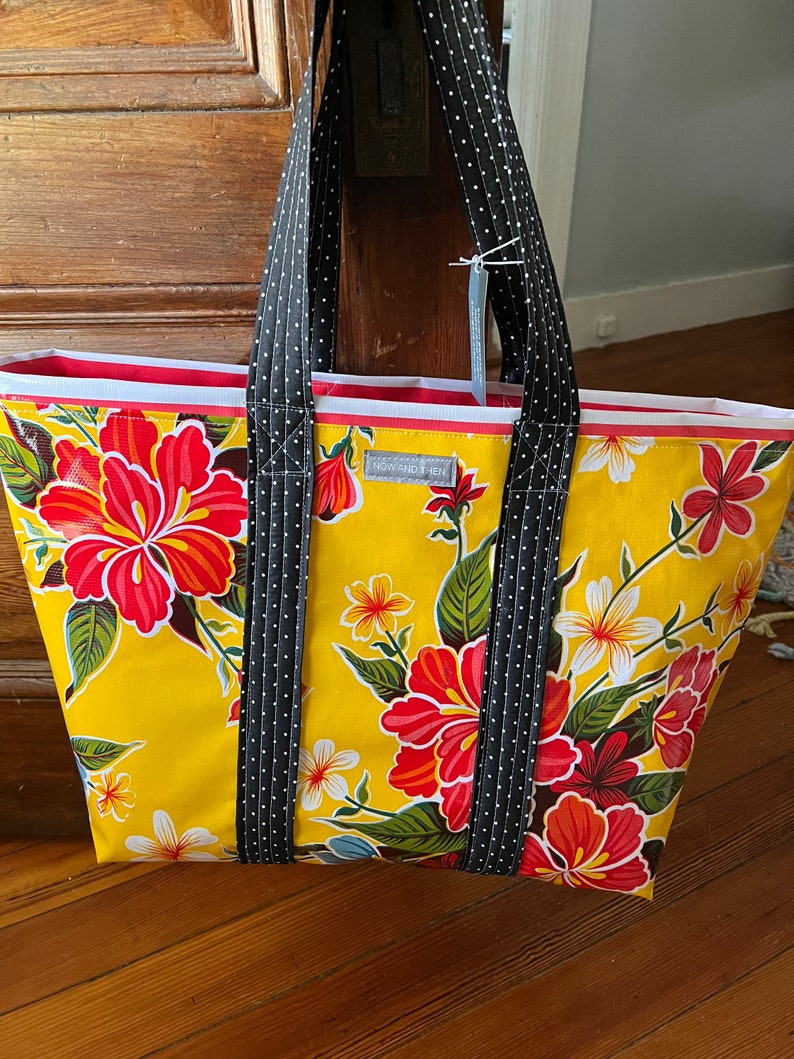 hibiscus patterned floral oilcloth tote bag on egg yolk yellow image 1