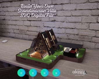 May include: A miniature model of a Scandinavian villa with an A-frame structure, illuminated interior, and a carport containing two small toy cars. The text Build Your Own Scandinavian Villa SVG Digital File is displayed above the model.
