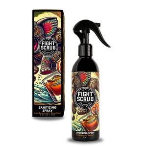 May include: A black spray bottle with a colorful design featuring an elephant, a glass of whiskey, and the text "Fight Scrub Keep It Clean". The bottle is labeled "Sanitizing Spray Sandalwood + Bourbon 2.65 oz / 75g".