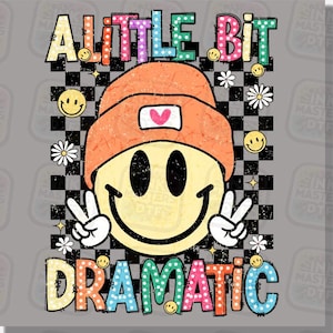 May include: A graphic design featuring a smiling face wearing an orange beanie with a heart, giving a peace sign. The words "A LITTLE BIT DRAMATIC" are in colorful, playful lettering, set against a checkered background with smiley faces and daisies.