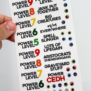 May include: A set of nine stickers with different power levels for Magic: The Gathering. Each sticker has a number from 4 to 9, a power level description, and a symbol. The stickers are on a white background.