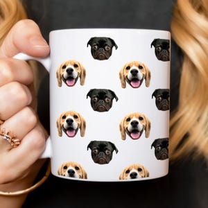 May include: White ceramic mug with a repeating pattern of dog faces. The dogs are a beagle and a pug. The mug has a black handle.