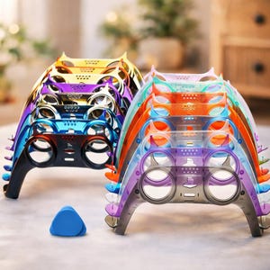 May include: A collection of colorful, layered, transparent game controller-shaped stands in various colors, including orange, purple, blue, and yellow. A small blue triangle is in the foreground. The stands appear to be made of plastic.