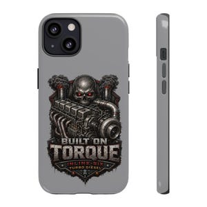 May include: A gray phone case featuring a graphic of a metallic skull with glowing red eyes positioned above an inline-six turbo diesel engine. The design includes black smoke and the text BUILT ON TORQUE, INLINE-SIX, and TURBO DIESEL in bold lettering.