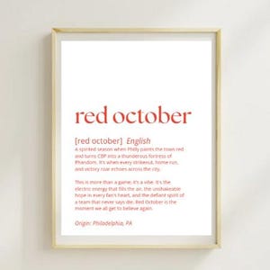 May include: A framed print with the words "red october" in red script. Below the title is a definition of "red october" in English, describing a spirited season in Philadelphia. The origin is listed as Philadelphia, PA.