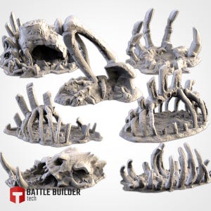 May include: Five different miniature skeletal remains of a creature, made of white plastic, on a white background. The skeletal remains are arranged in a variety of poses, including a skull, a ribcage, and a set of claws. The skeletal remains are all on a small base.