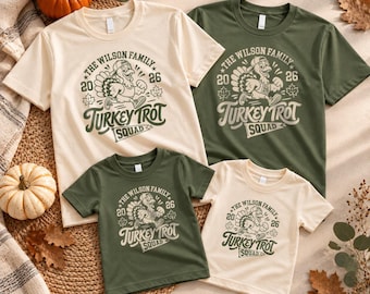 May include: Four short-sleeve t-shirts in cream and olive green colors, each featuring a graphic of a turkey wearing a baseball cap and sneakers. The text reads THE WILSON FAMILY, 2026, and TURKEY TROT SQUAD, accompanied by maple leaf icons.