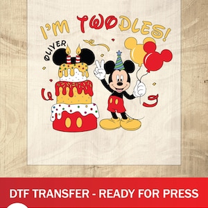 May include: A DTF transfer featuring Mickey Mouse celebrating a birthday. The design includes a two-tiered cake, balloons, and the text "I'm Twoodles!" and "Oliver". Mickey is wearing a party hat and red shorts.