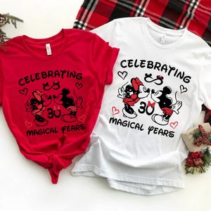 Close-up of a Disney inspired 30th anniversary shirt featuring Mickey and Minnie artwork surrounded by heart details and celebratory typography. The playful yet meaningful design captures three decades of love and is ideal for Disneyland anniversary vacations or romantic milestone events.