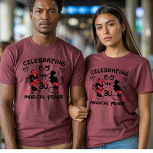Matching Disney couple shirts showcasing Mickey Minnie anniversary artwork with magical years lettering and heart accents. The coordinated outfits create a stylish and heartwarming look for anniversary dinners, Disneyland visits, or romantic photos.