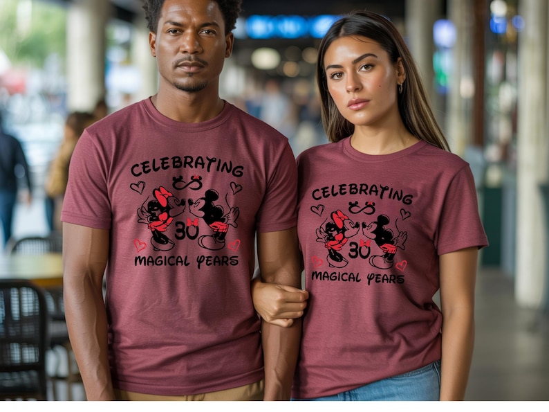 Matching Disney couple shirts showcasing Mickey Minnie anniversary artwork with magical years lettering and heart accents. The coordinated outfits create a stylish and heartwarming look for anniversary dinners, Disneyland visits, or romantic photos.