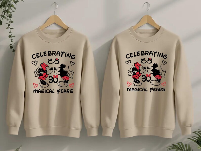 Matching Disney couple shirts showcasing Mickey Minnie anniversary artwork with magical years lettering and heart accents. The coordinated outfits create a stylish and heartwarming look for anniversary dinners, Disneyland visits, or romantic photos.