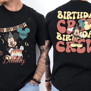 a black t-shirt with a cartoon character and text on the back.
