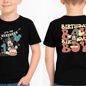 A black t-shirt with a Mickey Mouse design and text on the front and back.