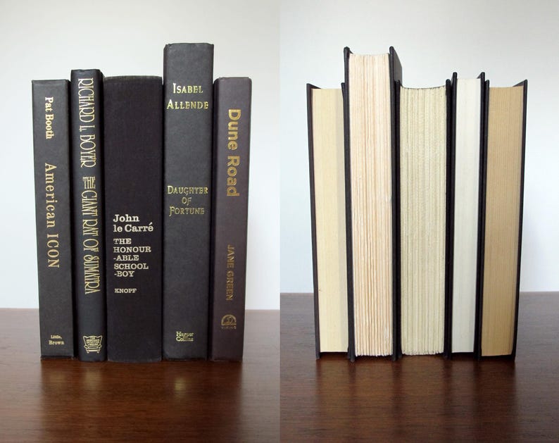 May include: A set of six black hardback books with gold lettering on the spines. The books are arranged in a vertical stack. The titles of the books are "American Icon", "The Giant Rat of Sumatra", "John le Carre The Honourable Schoolboy", "Daughter of Fortune", "Dune Road", and "The Giant Rat of Sumatra".
