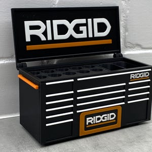 May include: A set of three ceramic mugs with a speckled, matte finish. The mugs are in shades of cream, light gray, and dark gray. Each mug has a simple, minimalist design, perfect for coffee or tea.