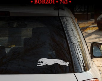 May include: A white vinyl decal of a running Borzoi dog applied to the rear window of a white vehicle. The text MULTIPLE DESIGNS! and BORZOI 742 is printed in white and red at the top of the image against a dark background.