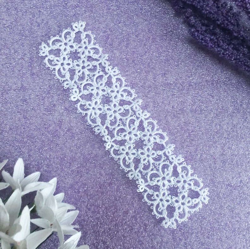 Tatted lace bookmark in white thread.