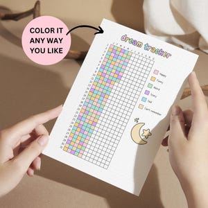 May include: A white dream tracker sheet with a grid for tracking dreams, featuring the text "dream tracker" and "COLOR IT ANY WAY YOU LIKE". The grid is color-coded for different dream types, with a moon and star graphic.