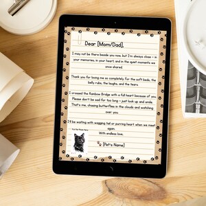 May include: A digital tablet shows a touching letter with paw print borders, addressed to "Mom/Dad." The letter includes a photo of a black cat and the text "I crossed the Rainbow Bridge." The theme is a pet memorial.