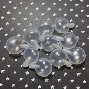 May include: A group of ten clear plastic dog squeaky balls with a small hole and a short tail on each ball.
