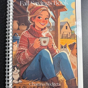 May include: A spiral-bound notebook with the title "Fall Savings Book". The cover illustration shows a woman in a red sweater holding a coffee cup with a heart. The image includes cats, a dog, and a barn. The text "Charma Budgets" is at the bottom.