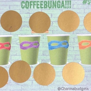 May include: A light green paper cup with a red, purple, blue, and orange mask design, resembling a Teenage Mutant Ninja Turtle. The image also shows several brown scratch-off circles and the text "COFFEEBUNGA!!!".