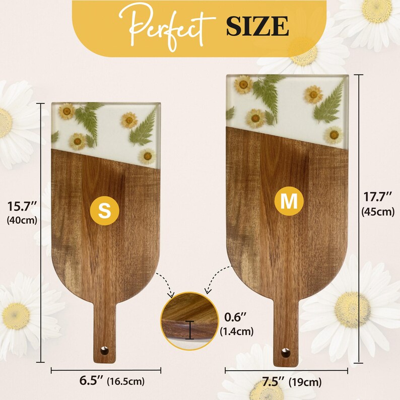 May include: Two wooden serving boards with a white epoxy top and pressed flowers. The smaller board measures 15.7 inches long and 6.5 inches wide. The larger board measures 17.7 inches long and 7.5 inches wide.
