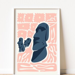 May include: A framed art print with a modern design, showcasing Moai statues in blue hues. The artwork incorporates pink floral and abstract shapes. The print is set against a white background, creating a minimalist aesthetic.