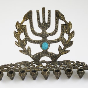 A  solid brass  vintage  hanukkah menorah,  judaica made in Israel by &quot;Tamar&quot; and signed.
