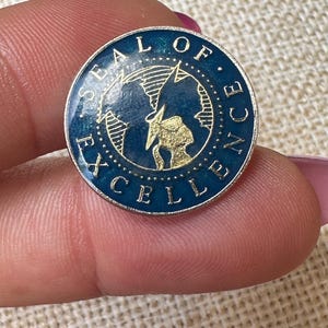 Vintage silver tone seal of excellence Lapel Pin, featuring navy blue background
