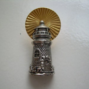 Vintage zilver- en goudkleurige vuurtorenspeld, gestempeld Avon