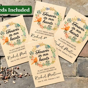 May include: Four seed packets with a floral design and the text "Forever in our hearts". Each packet has a different name and date printed on it. The packets are on a brick background.
