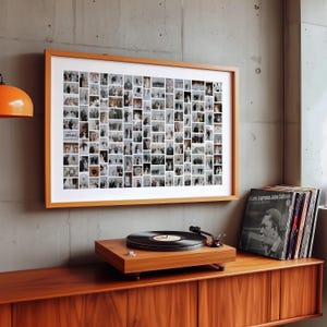 May include: A framed collage of small photographs hangs above a wooden record player and cabinet. The collage is in a light brown frame. A stack of vinyl records sits to the right. An orange lamp is visible on the left.