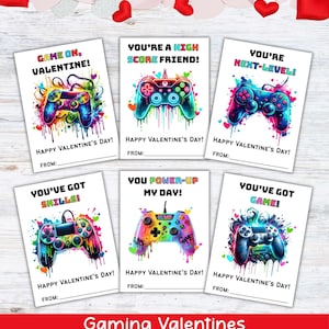 May include: Set of six gaming-themed Valentine's Day cards. Each card features a colorful, stylized game controller with phrases like "Game On, Valentine!" and "You're a High Score Friend!" Hearts and splashes of color decorate the cards.