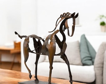 May include: A stylised metal sculpture of a horse, made from recycled metal, with a brown patina finish. The horse is standing on a black metal base.