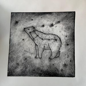 May include: A square black and white print featuring a stylized bear silhouette filled with a constellation pattern. The bear is positioned against a textured, dark background filled with scattered star shapes, creating a celestial effect.
