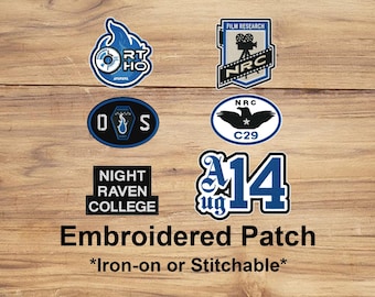May include: A collection of embroidered patches in various shapes, featuring text and graphics. The patches include the text "RT HO", "FILM RESEARCH", "NRC", "D S", "NIGHT RAVEN COLLEGE", "NRC C29", and "14 ug". The text "Embroidered Patch" is also present.