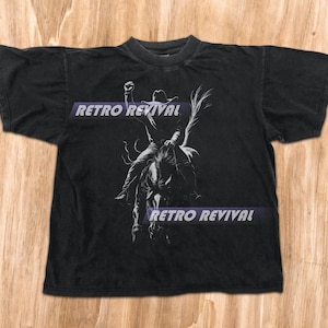 カウボーイシルエットグラフィックTシャツ、ユニセックスメンズ＆レディースグラフィックTシャツ、ヴィンテージウエスタンTシャツ、バッキングホースシャツ、カントリーロデオTシャツ